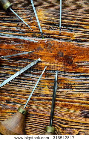 Different Gravers For Jewelry On A Wooden Background