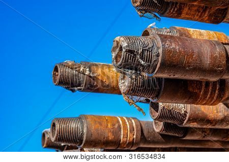 Oil Drill Pipe. Rusty Drill Pipes Were Drilled In The Well Section. Downhole Drilling Rig. Laying Th