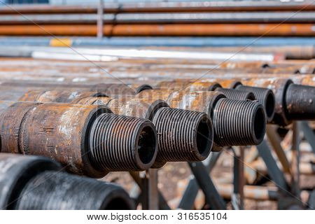 Oil Drill Pipe. Rusty Drill Pipes Were Drilled In The Well Section. Downhole Drilling Rig. Laying Th