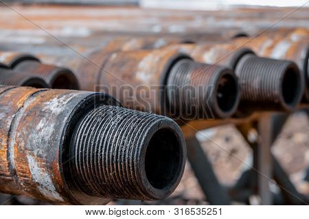 Oil Drill Pipe. Rusty Drill Pipes Were Drilled In The Well Section. Downhole Drilling Rig. Laying Th