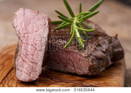 Grilled Steak On Wood With Rosemary On Wood