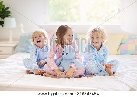 Kids Play In Bed. Children At Home.