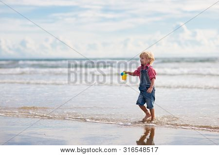Kids Play On Tropical Beach. Sand And Water Toy.