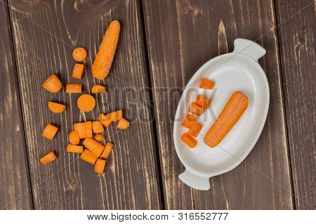 Group Of Two Whole Lot Of Pieces Of Stale  Orange Stale Baby Carrot Baby In A Wooden Bowl Flatlay Is