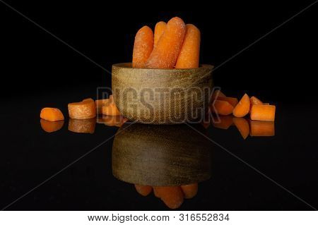 Group Of Four Whole Lot Of Pieces Of Stale  Orange Stale Baby Carrot Baby In Wooden Cup Isolated On 