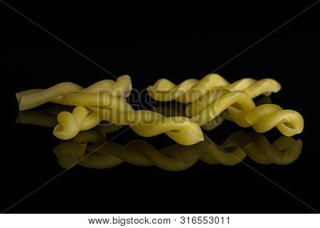 Group Of Five Whole Raw Pasta Gemelli Isolated On Black Glass