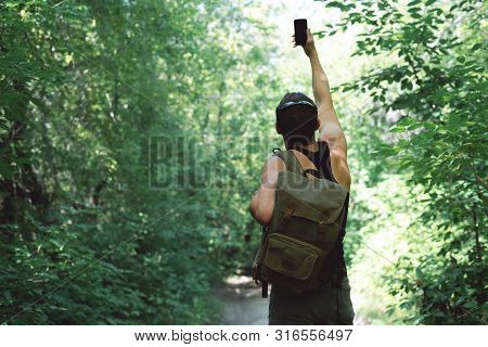 Man Is Stray In A Forest And Is Trying To Call Mobile Phone But No Signal Concept.