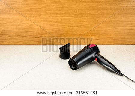 Electrical Hair Dryer For Household On The Woody Marbled Background With Copy Space