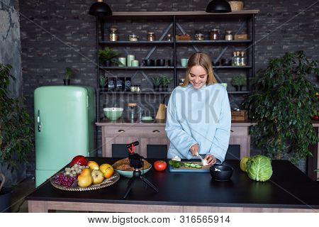 Young Beautiful Blonde Takes On Videos As She Cooks In The Kitchen