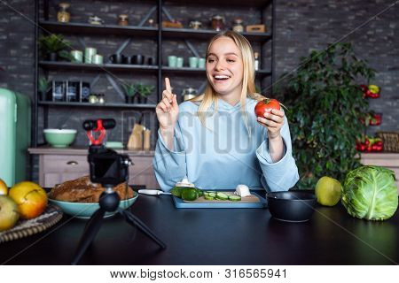 Young Beautiful Blonde Takes On Videos As She Cooks In The Kitchen