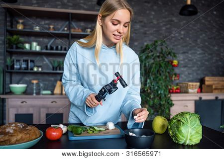 Young Beautiful Blonde Takes On Videos As She Cooks In The Kitchen