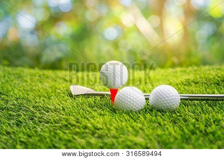 Golf Ball On Tee Ready To Be Shot.  Putting Golf Ball On Tee In Golf Course