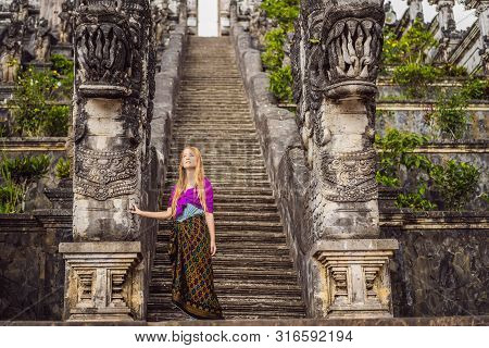 Young Woman Tourist On Background Of Three Stone Ladders In Beautiful Pura Lempuyang Luhur Temple. S