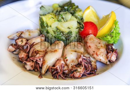 Baby Squid And Blitva, Garlic Mashed Potatoes With Chard, Served With Lettuce, Lemon Wedges, Parsley