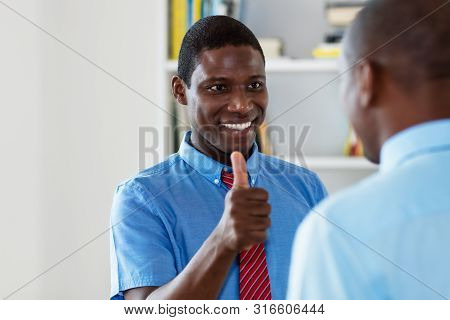 African American Busnessman With Colleague At Office Of Company