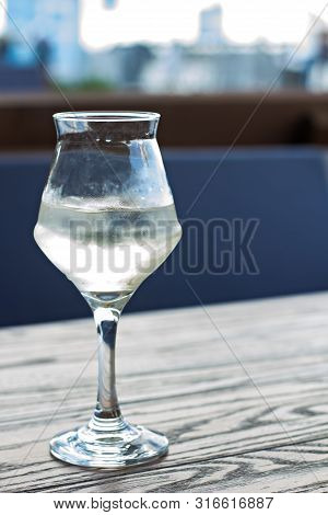 A Glass Of Cold White Wine On The Table On The Terrace Of A Summer Cafe. A Glass Of White Wine On Th