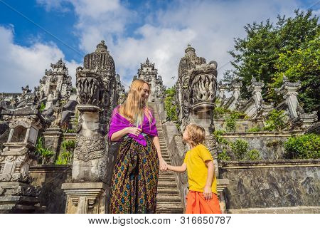Mother And Son Tourists On Background Of Three Stone Ladders In Beautiful Pura Lempuyang Luhur Templ