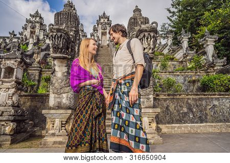 Happy Couple Of Tourists On Background Of Three Stone Ladders In Beautiful Pura Lempuyang Luhur Temp