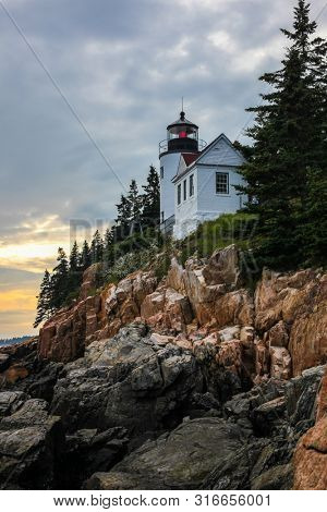 BASS HARBOR, MAINE, USA - JULY 8, 2013: Bass Harbor Lighthouse overlooking Atlantic Ocean in Summer evening