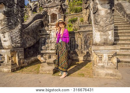 Young Woman Tourist On Background Of Three Stone Ladders In Beautiful Pura Lempuyang Luhur Temple. S