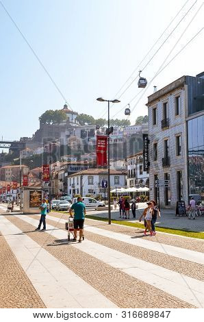 Porto, Portugal - August 31 2018: Tourists Walking On Promenade By River Douro On A Sunny Day. The E