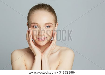 Portrait Of Beautiful Woman With Natural Make Up Touching Her Face.