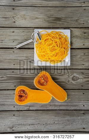 Overhead Top View Of Freshly Peeled Butternut Squash Noodles And Julienne Peeler
