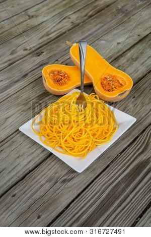 Top View Of Healthy Butternut Squash Noodles With Fork Stuck In Pasta