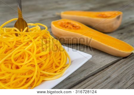 Butternut Squash Noodles With Fork Stuck In The Middle Of The Pasta.
