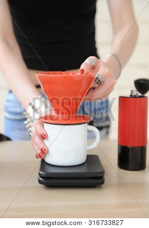 Girl Barista Brewing Drip Coffee In Red Pour Over V60 Hario Close Up Without Face. Manual Grinder