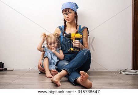 Mother In The Role Of Father: Mother And Daughter Together Do Repair And Sat Down To Take A Breath B