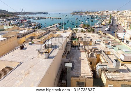 Traditional Fishing Boats Called Luzzu In The Bay Of The Village Marsaxlokk. Malta.