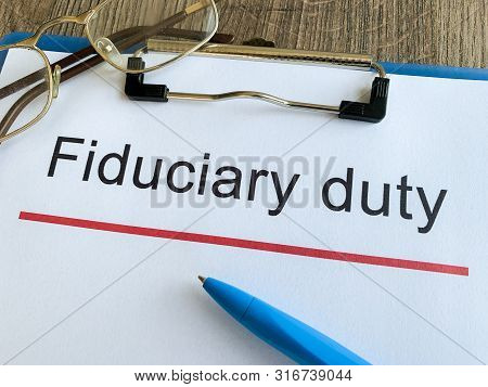 Paper With Text Fiduciary Duty On Wood Table.