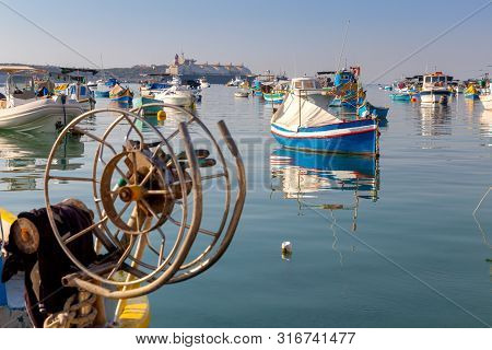 Traditional Fishing Boats Called Luzzu In The Bay Of The Village Marsaxlokk. Malta.