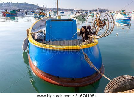 Traditional Fishing Boats Called Luzzu In The Bay Of The Village Marsaxlokk. Malta.