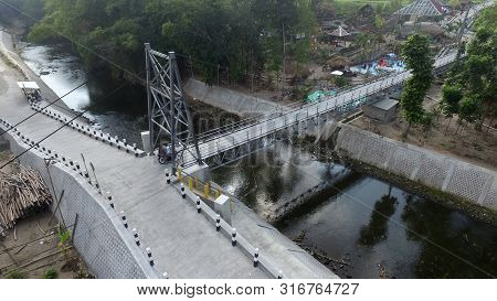A Suspension Bridge Crosses The River. Supporting Inter-regional Transportation Facilities. Traffic 