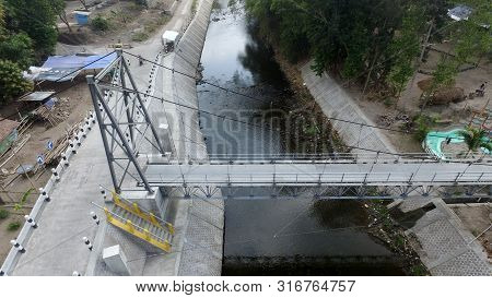 A Suspension Bridge Crosses The River.supporting Inter-regional Transportation Facilities.traffic In
