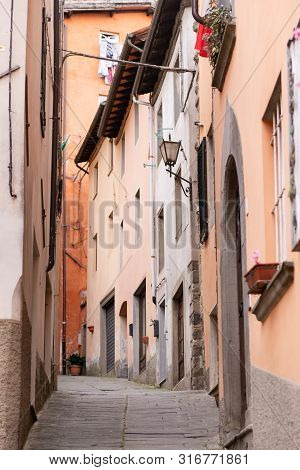 The Town Of Barga. Italy. Summer 2019. Narrow Street Rising Up. Street In The Central Part Of The Hi