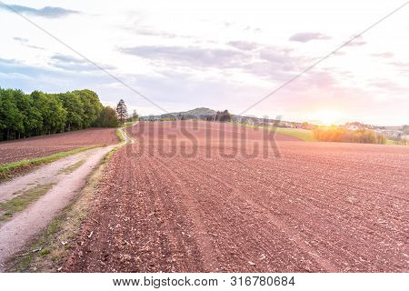 Country Road In Rural Agricultural Landscape. Red Soil Fields Around Nova Paka, Czech Republic
