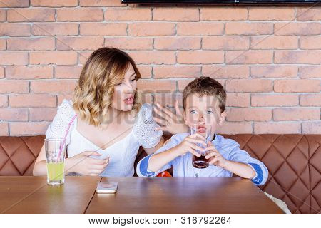 Young Mom Is Looking Angry With Her Boy, Telling Him Something, He Looks Like He Doesn Not Care, Not