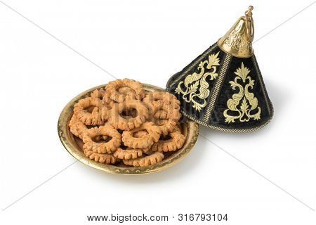 Traditional festive Moroccan tagine with Kaak cookies anise cookies isolated on white background