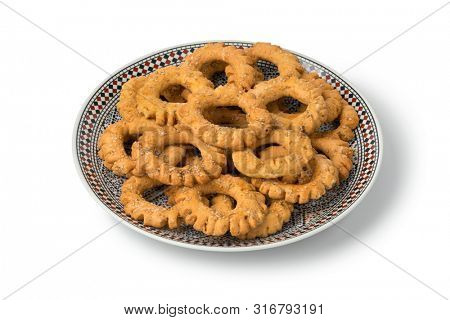Traditional dish with festive Moroccan Kaak, anise cookies, isolated on white background