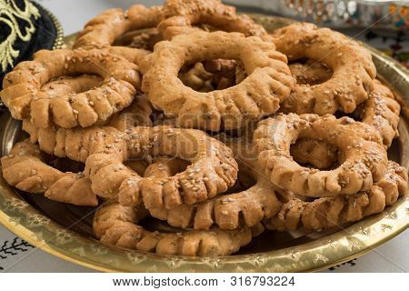 Festive traditional Tagine with festive Moroccan Kaak, anise cookies, close up
