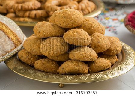 Festive tagine with traditional homemade Moroccan ghoriba cookies close up