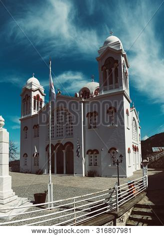 Church Of Holy Cross With Blue Sky And White Clouds In Pedoulas Village. Nicosia District, Cyprus. T