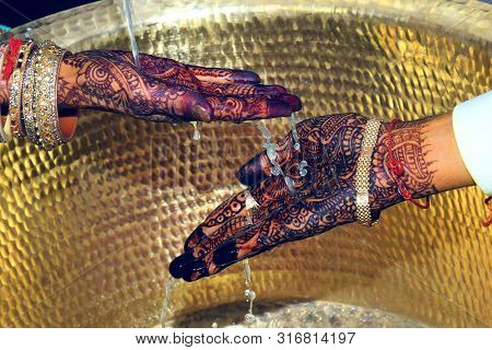 Wedding Hands In India Marriage With Brass Background.