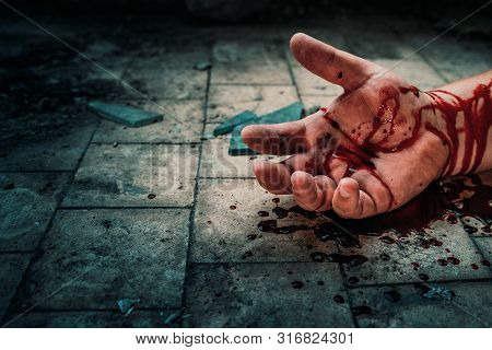 Crime Scene With Human Hand In Blood On Floor Of Killed Man By Murder, Dead Body Part Close Up.