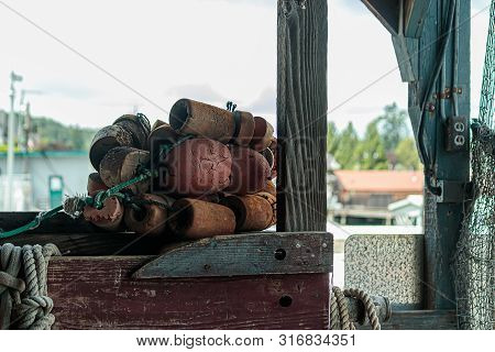 Fishing Net With Bouys Hang In Front Of Harbor Town
