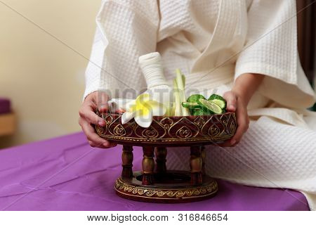 Asian Woman Holding Salt Scrub For Massage At Spa.