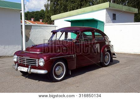 Vimmerby, Smaland, Sweden - August 2, 2019: Bordeaux Red Volvo Pv 444 A. Nobody In The Vehicle.
